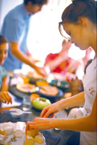 People serving themselves at a table.