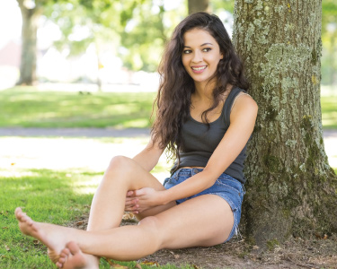 Woman sitting under a tree