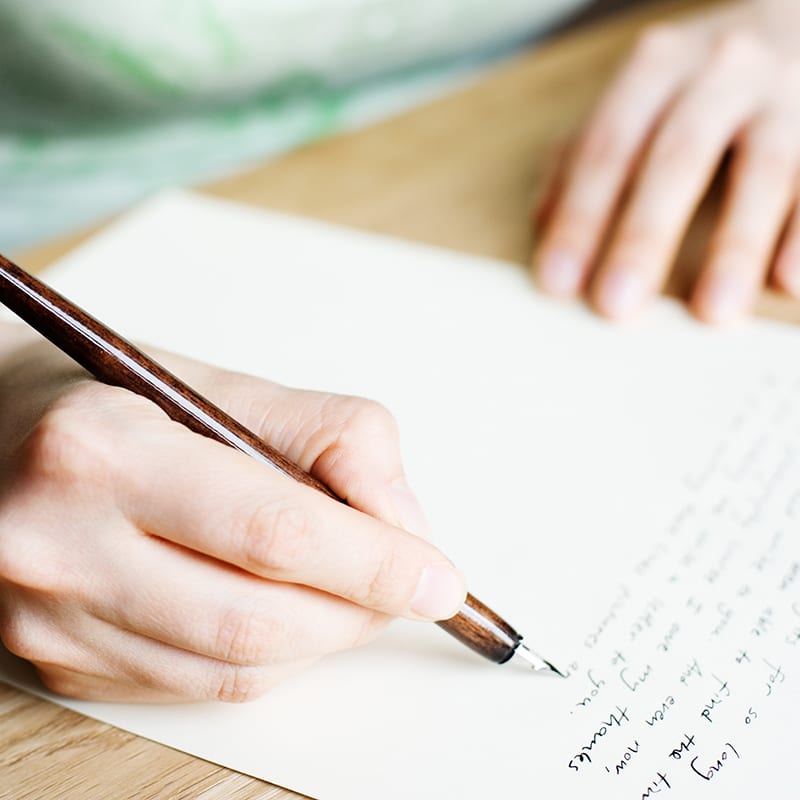 Person writing a letter.