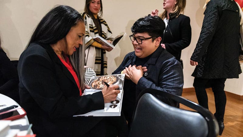 Author Toni Tipton-Martin signing her cookbook. Photo courtesy of Robert Wade.