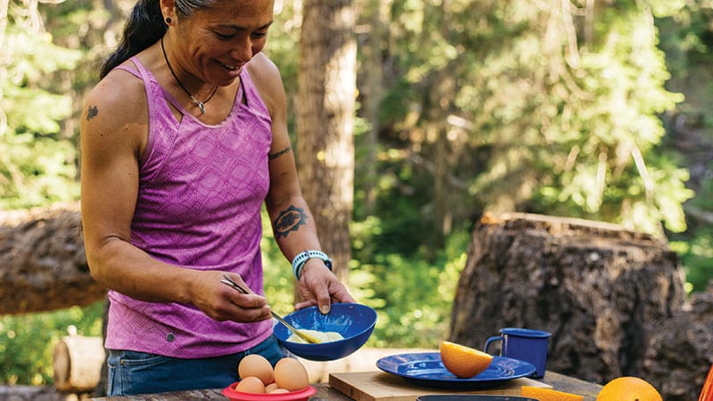 Maria Hines cooking outside