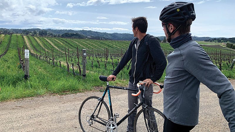 Biker gazing at a crop field. Photo courtesy of Sarah Reeves.