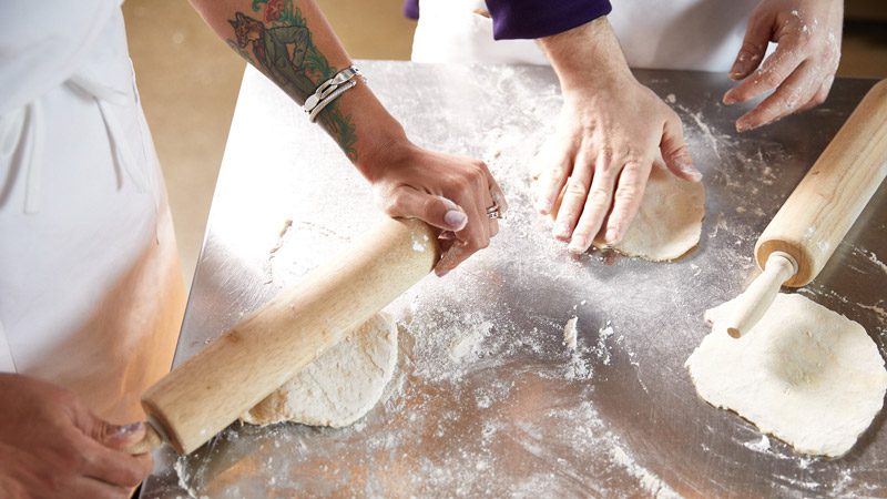 cooking class students rolling pins